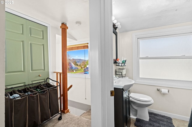 410 E D St, Rainier, OR 97048 - bathroom with toilet, vanity, and baseboards