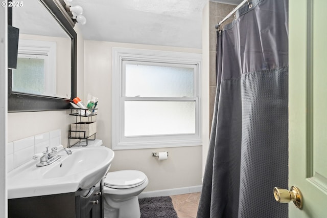 410 E D St, Rainier, OR 97048 - bathroom with tile patterned flooring, toilet, vanity, a shower with curtain, and baseboards