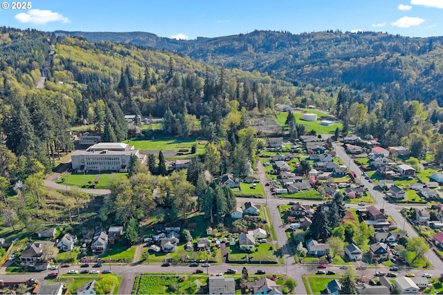 410 E D St, Rainier, OR 97048 - view of property location with a mountain backdrop and a forest