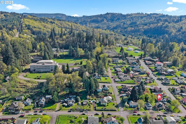 410 E D St, Rainier, OR 97048 - aerial view of property and surrounding area with a mountain backdrop and a forest