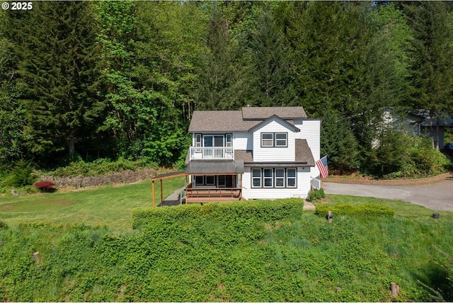 42810 NE 244th Ave, Amboy, WA 98601 - traditional home featuring a front lawn, a wooded view, asphalt driveway, and a balcony