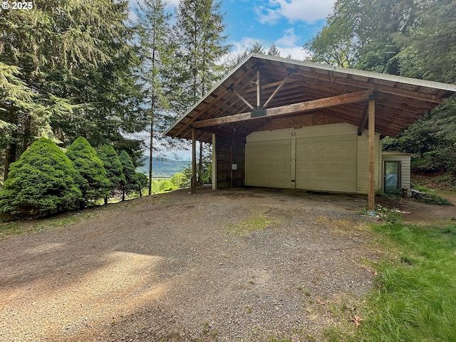 42810 NE 244th Ave, Amboy, WA 98601 - garage featuring dirt driveway and a detached carport