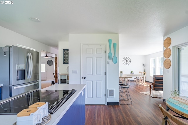 42810 NE 244th Ave, Amboy, WA 98601 - kitchen featuring stainless steel refrigerator with ice dispenser, black electric cooktop, dark wood-style flooring, ceiling fan, and light countertops