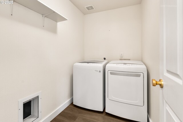 clothes washing area with washer and dryer, dark wood-style flooring, laundry area, baseboards, and visible vents