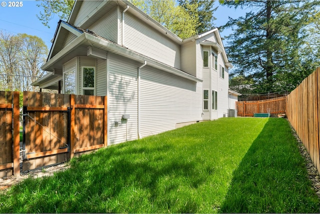 view of property exterior with a lawn, cooling unit, a gate, and a fenced backyard