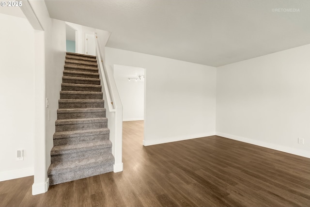 stairs with baseboards and wood finished floors