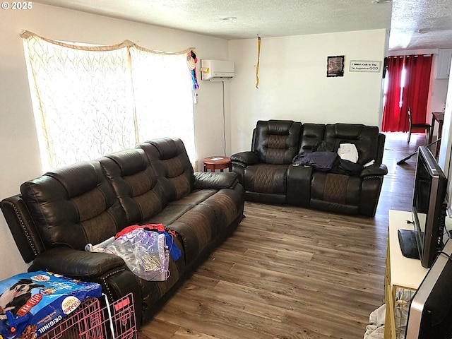 729 NW Evans St, Sheridan, OR 97378 - living area featuring a wall unit AC, wood finished floors, and a textured ceiling