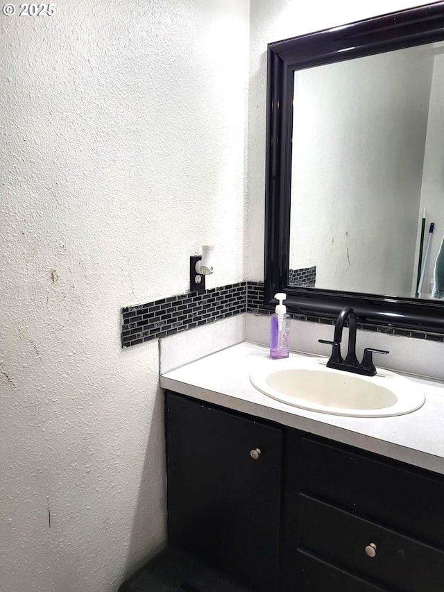 729 NW Evans St, Sheridan, OR 97378 - bathroom featuring vanity, tasteful backsplash, and a textured wall