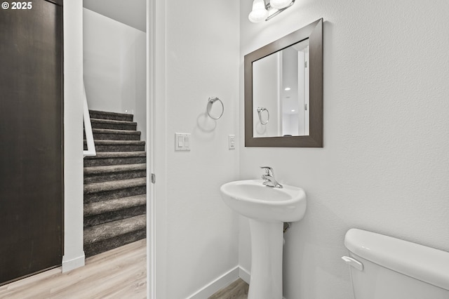 bathroom featuring hardwood / wood-style floors and toilet