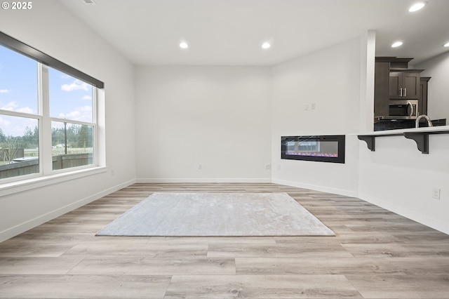 interior space featuring sink and light hardwood / wood-style floors