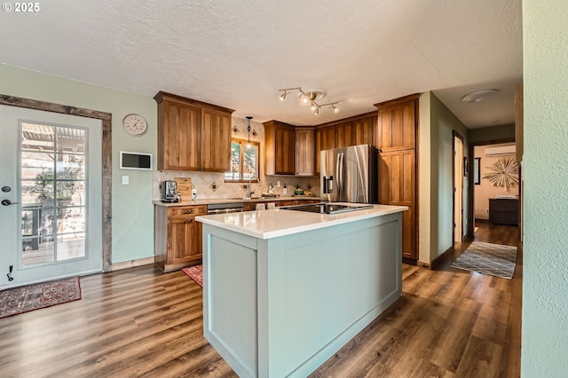 190 SE Shafford St, Estacada, OR 97023 - kitchen featuring stainless steel fridge with ice dispenser, dark wood-style flooring, light countertops, tasteful backsplash, and a textured ceiling