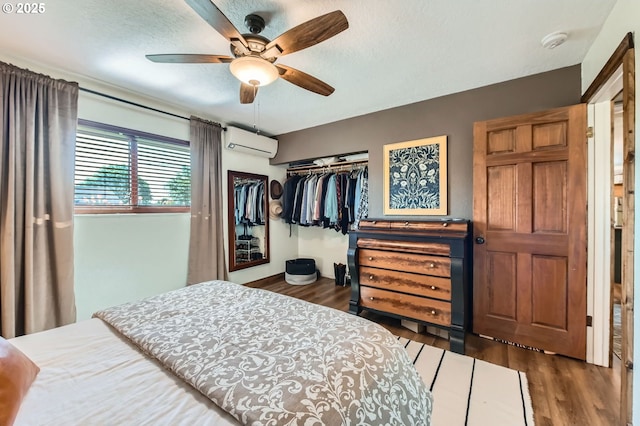 190 SE Shafford St, Estacada, OR 97023 - bedroom featuring a wall mounted air conditioner, a closet, wood finished floors, and ceiling fan
