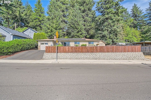 190 SE Shafford St, Estacada, OR 97023 - view of front of property featuring a fenced front yard, asphalt driveway, and solar panels