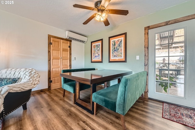 190 SE Shafford St, Estacada, OR 97023 - dining space featuring an AC wall unit, wood finished floors, a ceiling fan, and a textured ceiling
