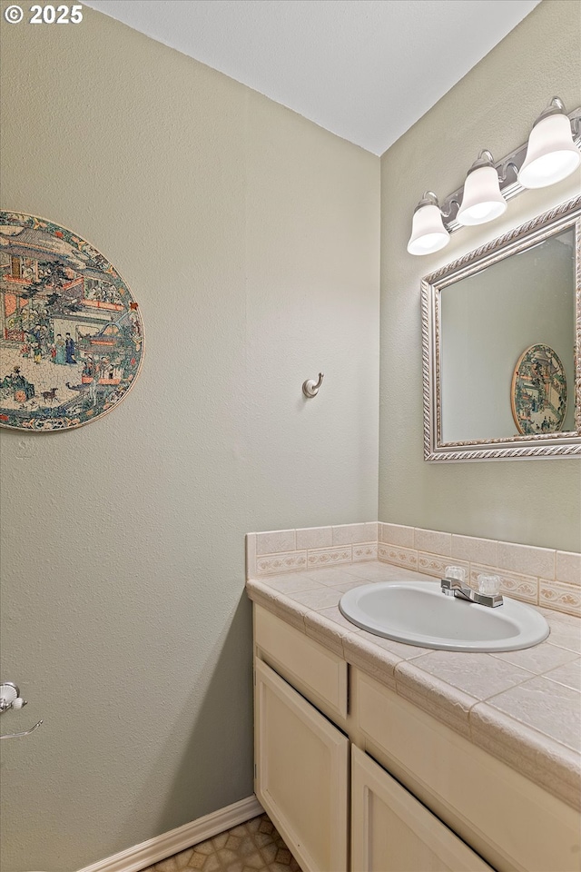 bathroom featuring vanity and baseboards