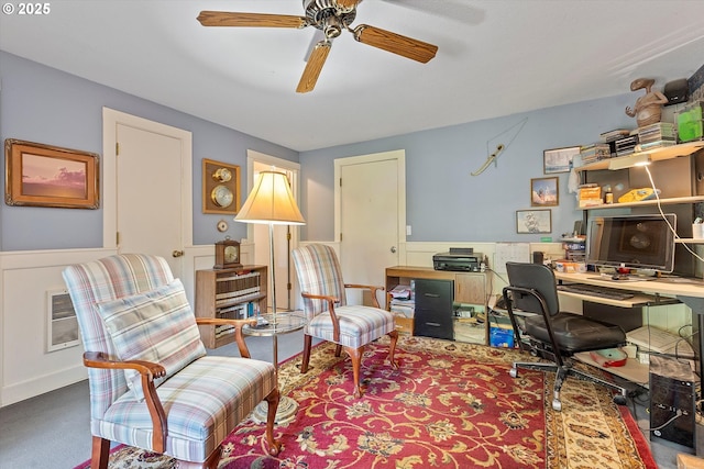 office featuring a wainscoted wall, ceiling fan, and carpet floors