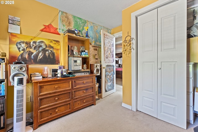 bedroom with light carpet, a closet, and a textured ceiling