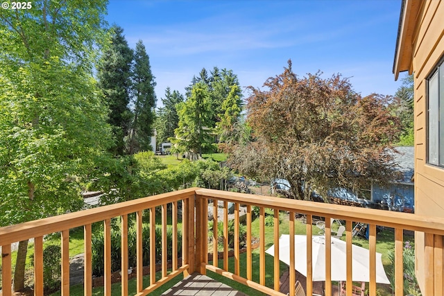wooden deck featuring view of scattered trees