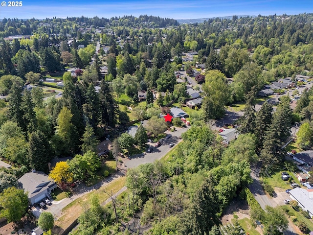 aerial view of property and surrounding area with nearby suburban area