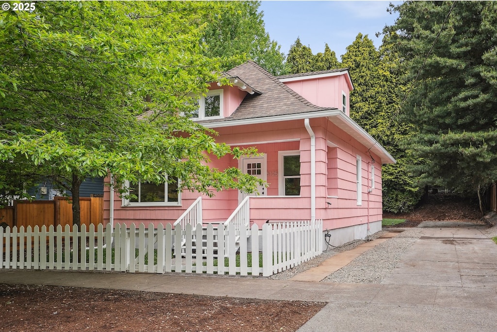 5125 NE Flanders St, Portland, OR 97213 - bungalow with a shingled roof and a fenced front yard