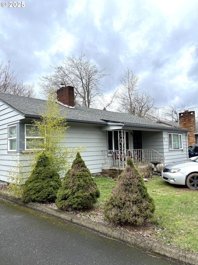 301 SE 129th Ave, Portland, OR 97233 - ranch-style house featuring a chimney, roof with shingles, a porch, and a front lawn