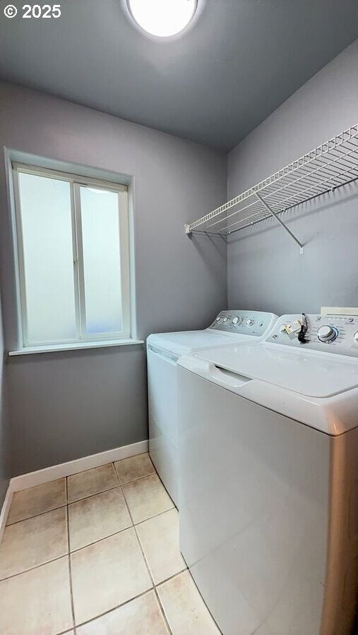 301 SE 129th Ave, Portland, OR 97233 - laundry room with washing machine and clothes dryer, light tile patterned floors, and baseboards