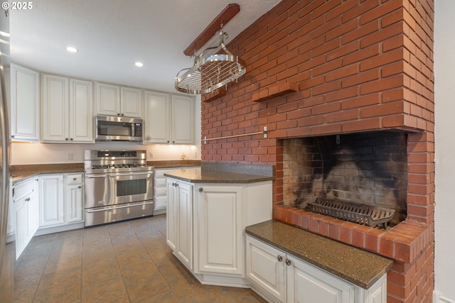 7105 Mississippi Dr, Vancouver, WA 98664 - kitchen with stainless steel appliances, white cabinetry, and recessed lighting