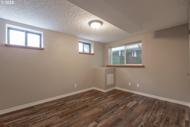 7105 Mississippi Dr, Vancouver, WA 98664 - basement with dark wood-style flooring, baseboards, and a textured ceiling