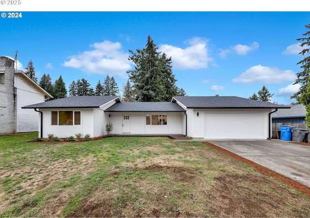 ranch-style house featuring a front lawn and a garage