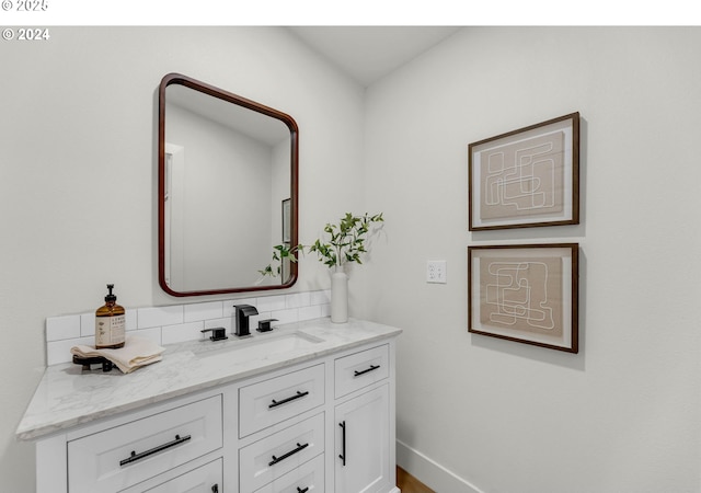 bathroom featuring vanity and tasteful backsplash