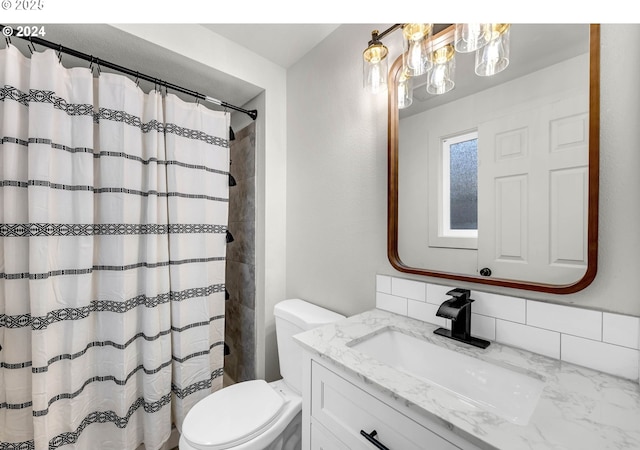 bathroom featuring tasteful backsplash, vanity, a shower with shower curtain, and toilet