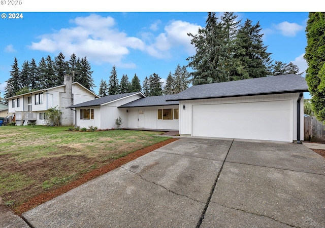 view of front of property with a front yard and a garage