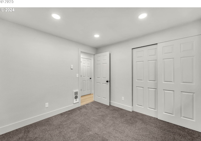 unfurnished bedroom with a closet and carpet floors