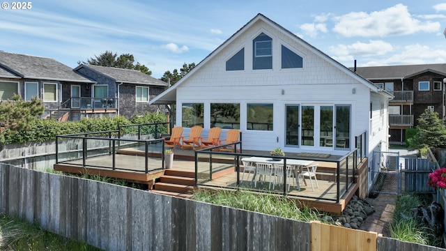 1209 N Prom, Seaside, OR 97138 - back of property featuring a fenced backyard, outdoor dining area, and a wooden deck