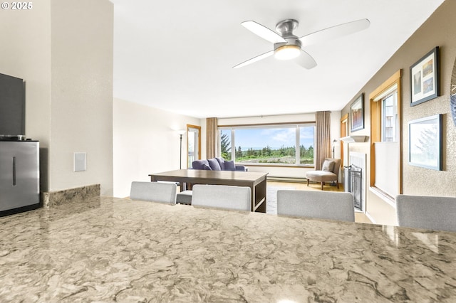 2801 Willows Rd Unit 1, Seaview, WA 98644 - kitchen with ceiling fan, a fireplace, and stone countertops