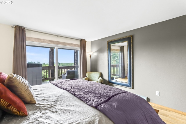 2801 Willows Rd Unit 1, Seaview, WA 98644 - bedroom featuring access to outside, wood finished floors, and multiple windows