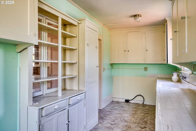 644 4th St, Myrtle Point, OR 97458 - kitchen featuring tile counters and white cabinets