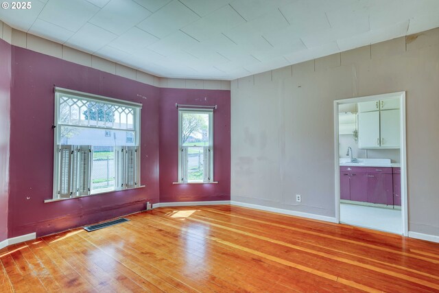 644 4th St, Myrtle Point, OR 97458 - empty room featuring baseboards, light wood-style floors, a sink, and visible vents