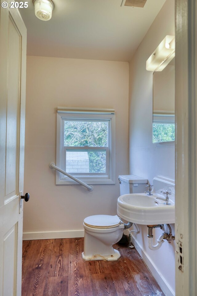644 4th St, Myrtle Point, OR 97458 - bathroom featuring toilet, wood finished floors, baseboards, and a wealth of natural light