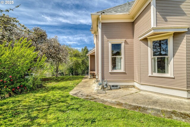 644 4th St, Myrtle Point, OR 97458 - view of home's exterior featuring a yard, a shingled roof, and a patio area