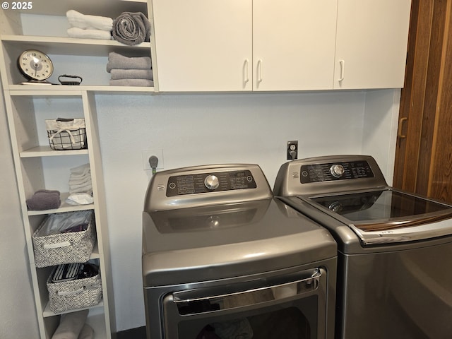 washroom with cabinet space and separate washer and dryer