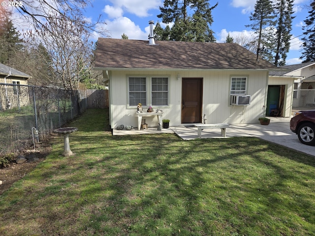 bungalow-style home featuring a shingled roof, a front yard, and a fenced backyard