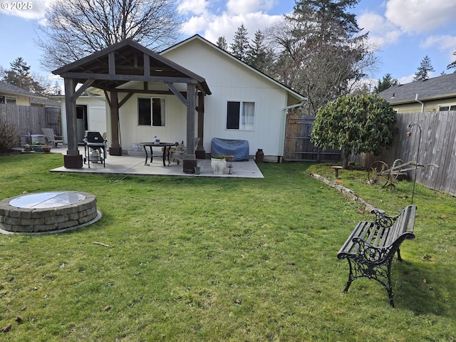 rear view of property featuring a gazebo, a patio area, and a fenced backyard