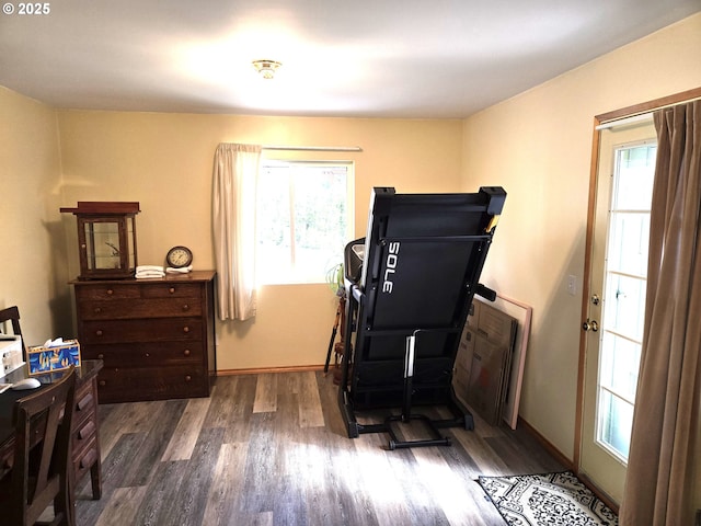 interior space featuring baseboards and wood finished floors