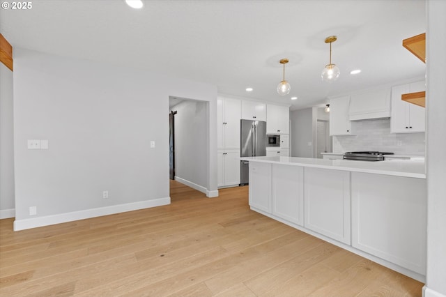 19338 Inishbride Ct, Oregon City, OR 97045 - kitchen with stainless steel appliances, light countertops, recessed lighting, light wood finished floors, and white cabinets