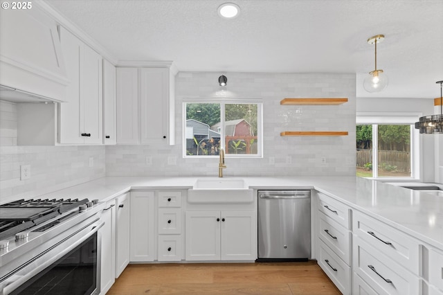 19338 Inishbride Ct, Oregon City, OR 97045 - kitchen featuring appliances with stainless steel finishes, tasteful backsplash, white cabinetry, and healthy amount of natural light
