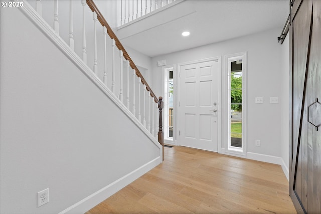19338 Inishbride Ct, Oregon City, OR 97045 - entryway with stairway, light wood-style flooring, recessed lighting, and a barn door