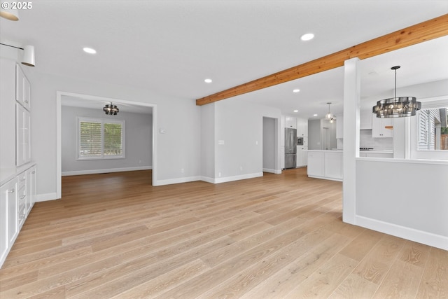 19338 Inishbride Ct, Oregon City, OR 97045 - unfurnished living room with a chandelier, beamed ceiling, recessed lighting, and light wood-style floors