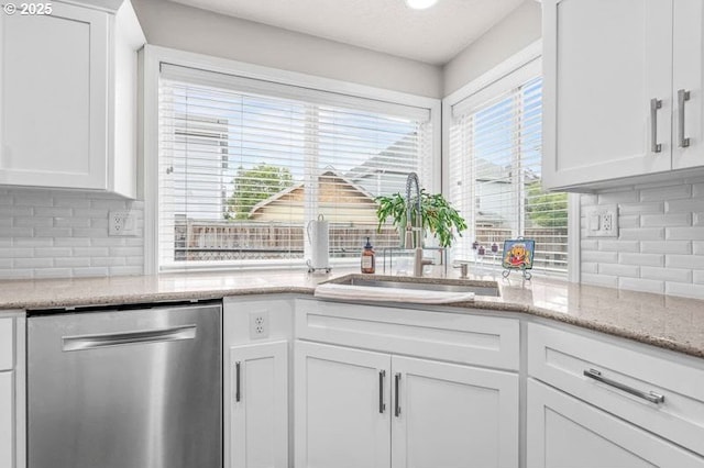 715 Shadowwood Loop, Keizer, OR 97303 - kitchen with stainless steel dishwasher, tasteful backsplash, white cabinets, and light stone counters