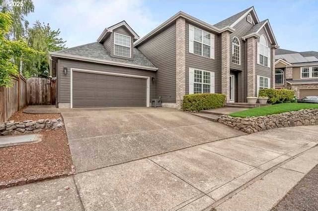 715 Shadowwood Loop, Keizer, OR 97303 - traditional home with concrete driveway, roof with shingles, and an attached garage